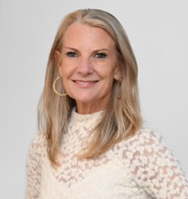 Prenter Mosey headshot, wearing a white lace turtleneck, white background