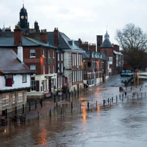 image of water flooding a street full of high net worth houses & buildings