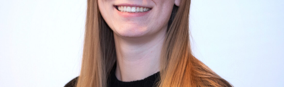 Young woman, long blonde hair in a black crewneck blouse