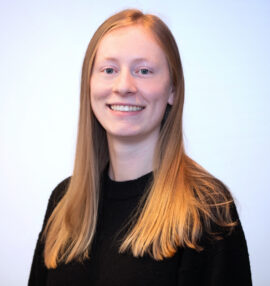 Young woman, long blonde hair in a black crewneck blouse