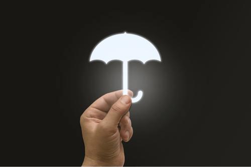 Hand holding a white illuminated umbrella icon representing commercial umbrella insurance. Simpson McCrady.