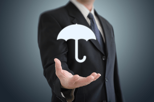 Businessman in a suite holding his palm out with a white umbrella icon above it representing the offer of umbrella insurance. Simpson McCrady.