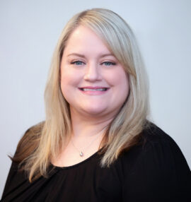 Ashley Greene headshot, black shirt, white background